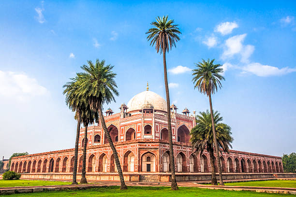 Daytime view of Humayunβs Tomb, fine example of Great Mughal architecture, UNESCO World Heritage, Delhi, India. Birds flying in the blue sky.